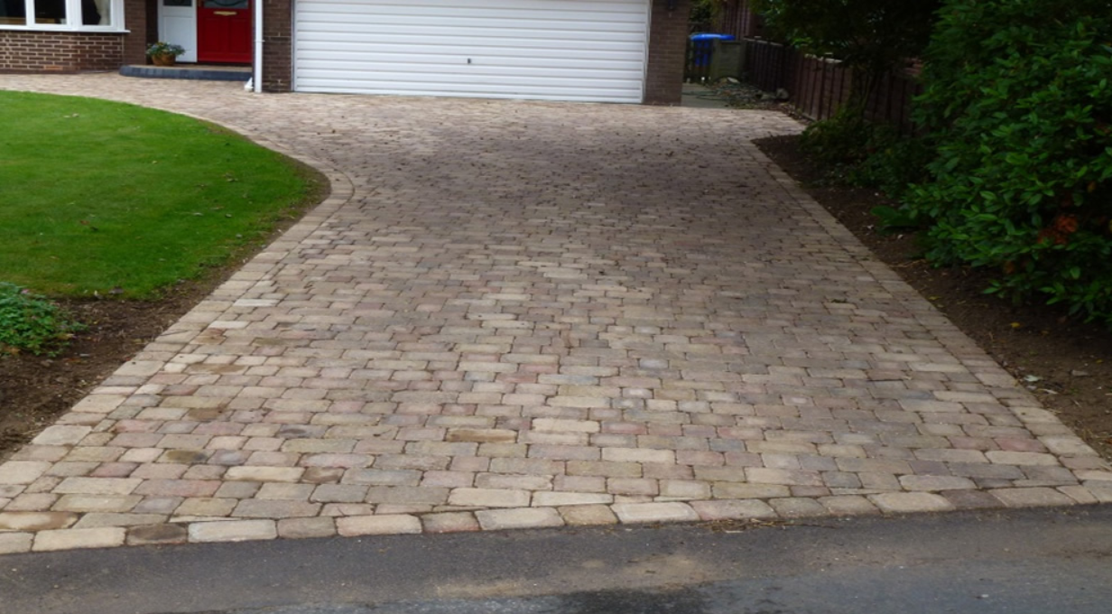 Block paved driveway in buff tones with a gently curved edge