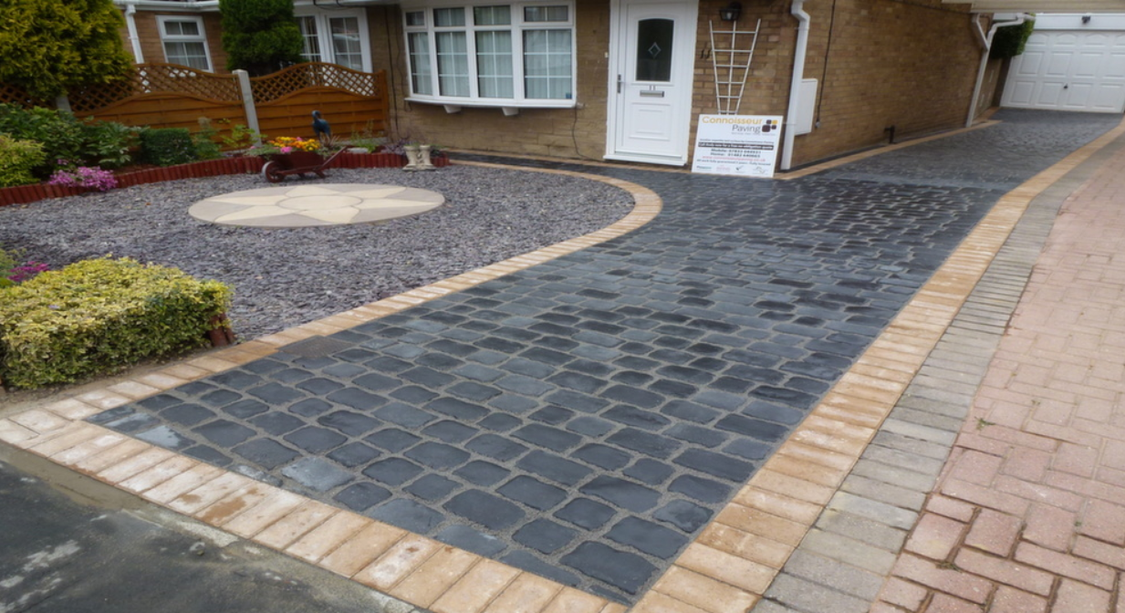Charcoal setts driveway with buff soldier course border