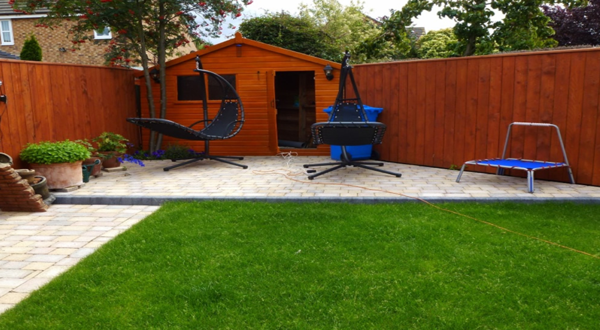 Paved seating area with artificial lawn and summer house
